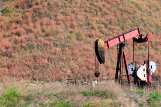 An oil pumpjack working in a rural field