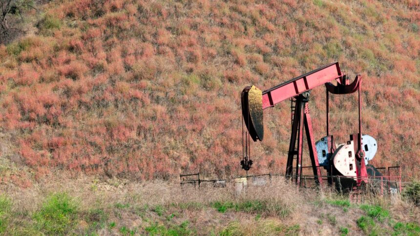 An oil pumpjack working in a rural field