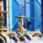 A close up of steel pipes and valves on pipeline infrastructure