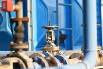 A close up of steel pipes and valves on pipeline infrastructure