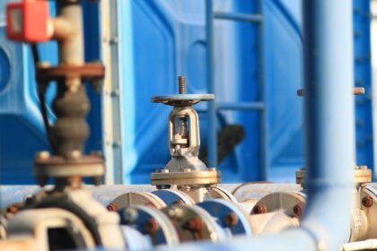 A close up of steel pipes and valves on pipeline infrastructure