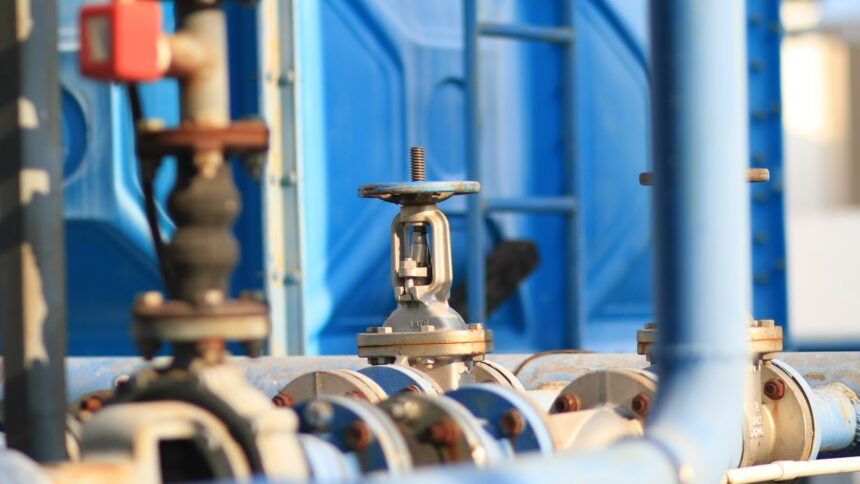 A close up of steel pipes and valves on pipeline infrastructure