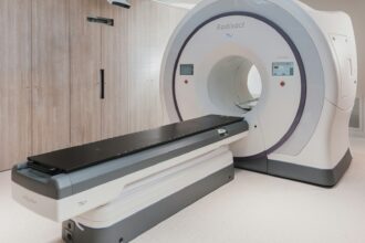 A magnetic resonance imaging scanner standing in an empty hospital room