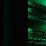 Rows of server racks lit green inside a data centre hall