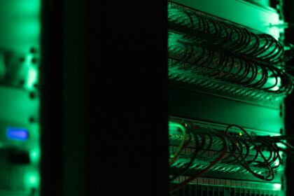 Rows of server racks lit green inside a data centre hall