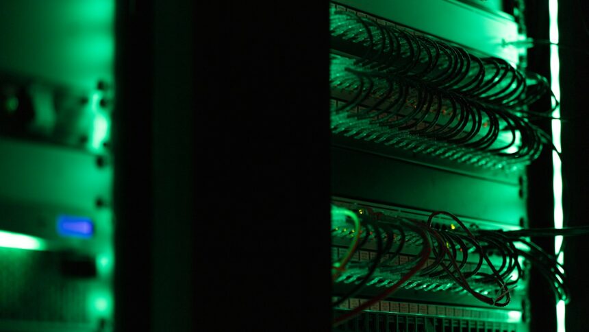 Rows of server racks lit green inside a data centre hall
