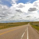 A two-lane highway crossing open prairie near Elkwater, Alberta