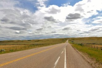 A two-lane highway crossing open prairie near Elkwater, Alberta