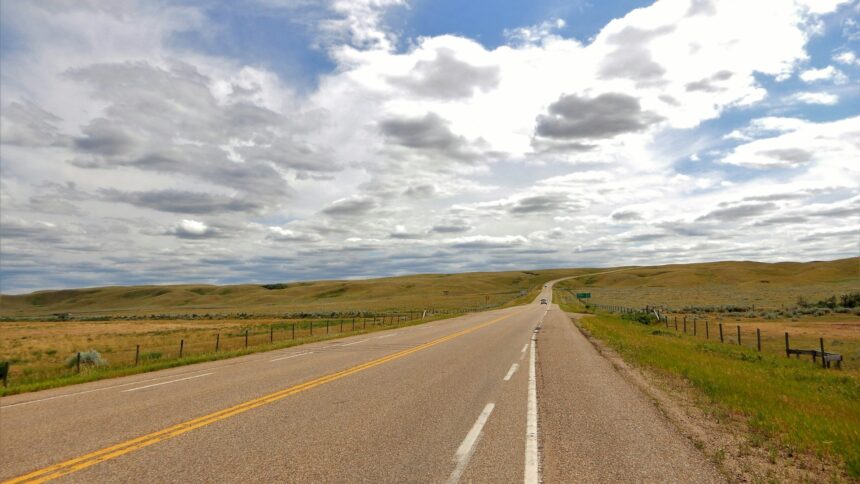 A two-lane highway crossing open prairie near Elkwater, Alberta