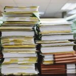 Stacks of paper documents with coloured tabs