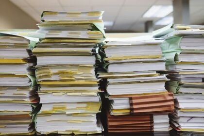Stacks of paper documents with coloured tabs