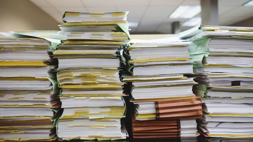 Stacks of paper documents with coloured tabs