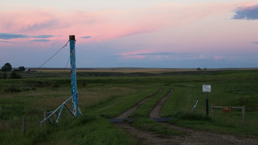 A power transmission tower on the prairie near Three Hills, Alberta at dusk