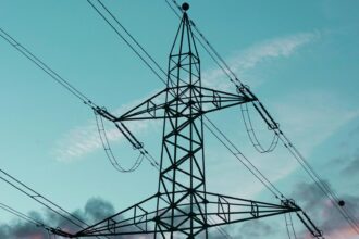 High voltage transmission towers carrying lines across open country