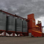 A grain elevator standing beside railway tracks in Vulcan, Alberta