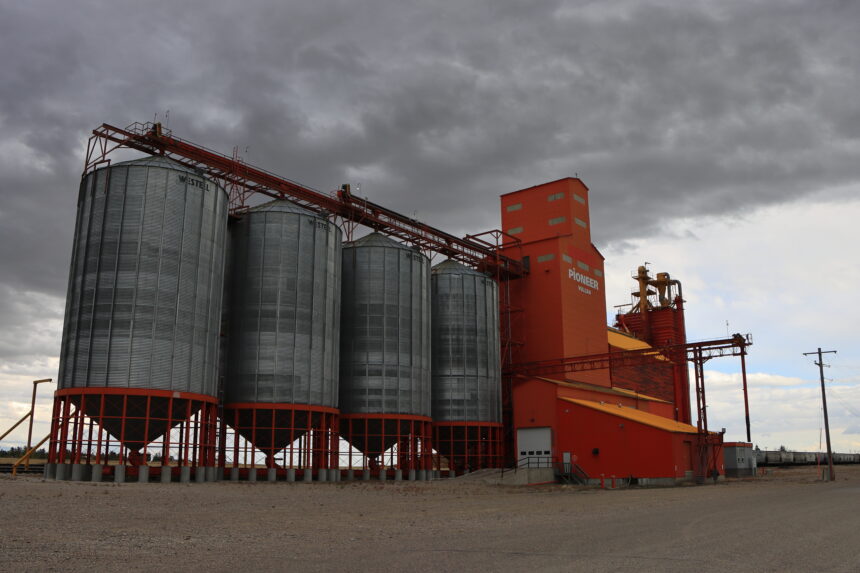 A grain elevator standing beside railway tracks in Vulcan, Alberta