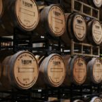Whisky barrels stacked on racks in a distillery warehouse