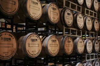 Whisky barrels stacked on racks in a distillery warehouse