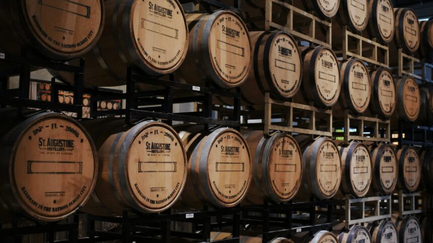 Whisky barrels stacked on racks in a distillery warehouse