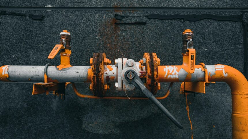Orange valve assembly on a gas pipeline fitting