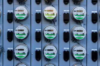 Rows of electricity meters mounted on a utility panel