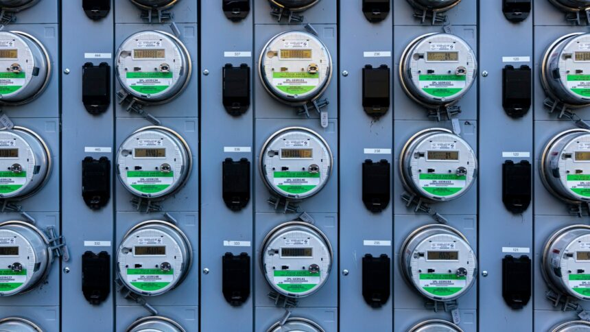 Rows of electricity meters mounted on a utility panel