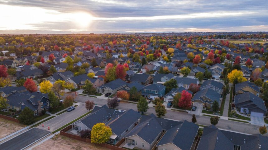 Aerial view of a residential neighbourhood with autumn trees at sunset