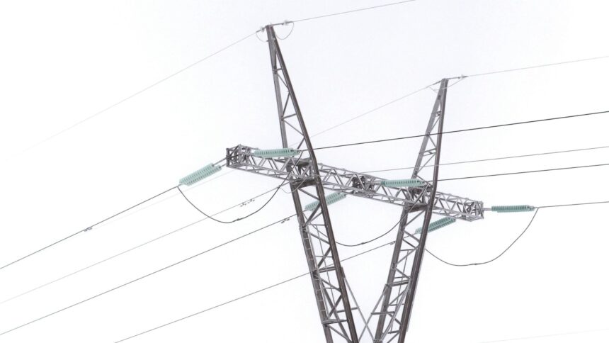 Steel transmission pylon and power lines covered in frost against a white winter sky