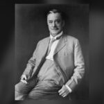 Black and white portrait of a seated man in a suit, Bob Edwards, editor of the Calgary Eye Opener